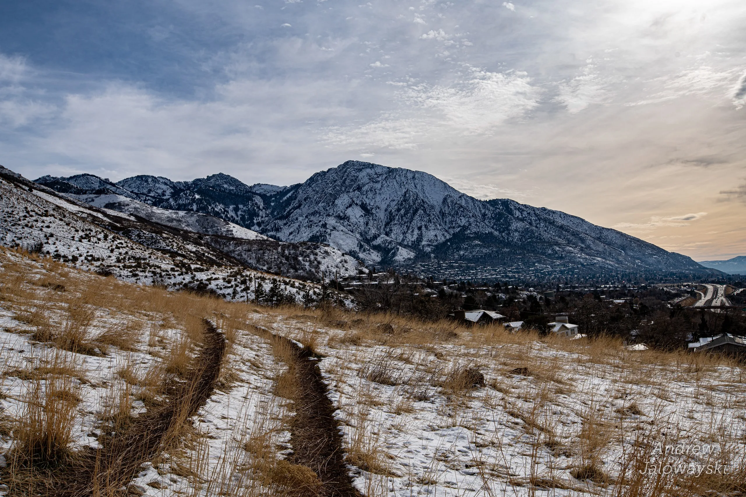 Snowy trail on Granger Mountain with peaks beyond