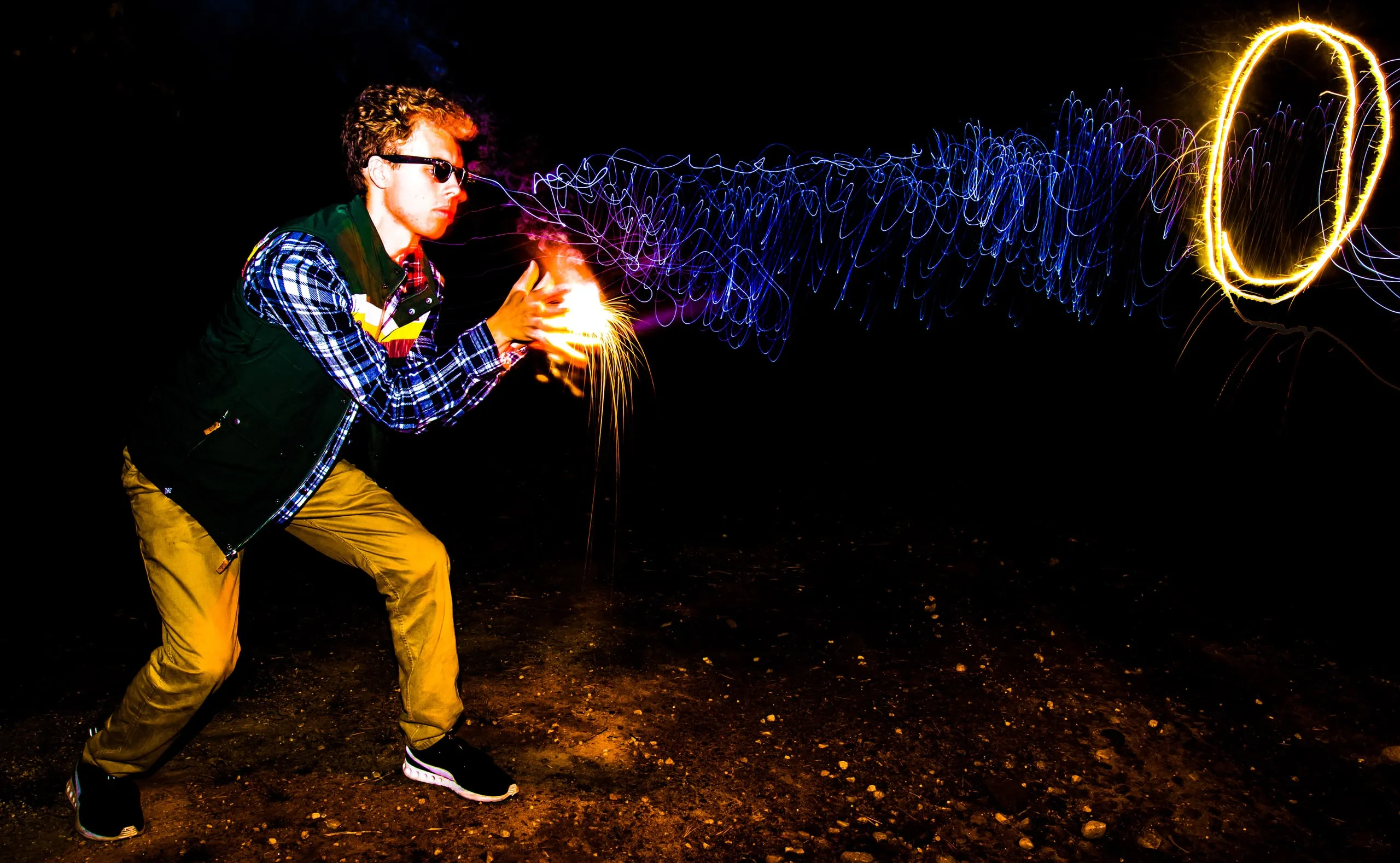 Person spinning a ball of light, leaving a glowing trail