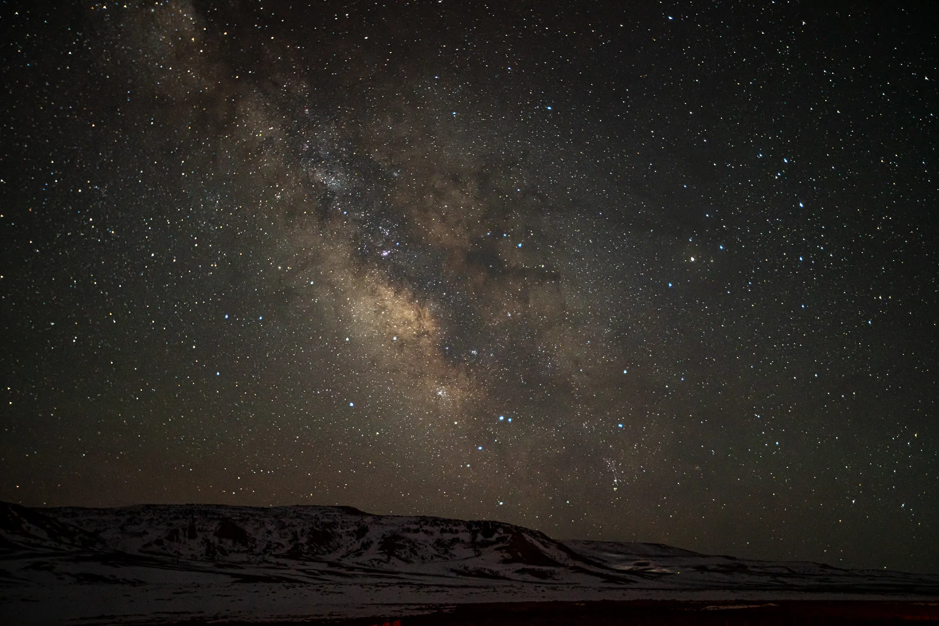 Milky Way rising over dark hills