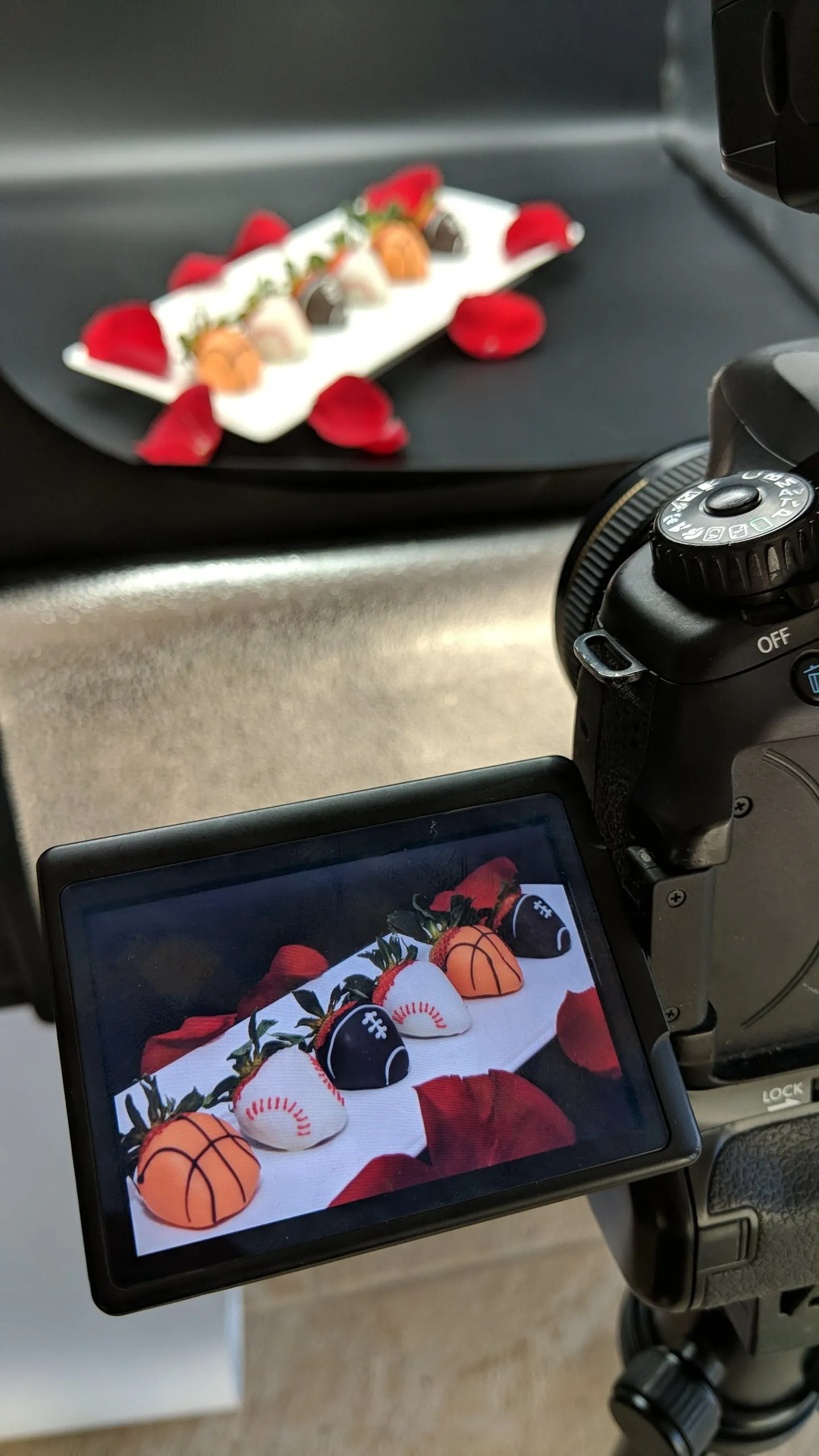 Desserts photographed on a tablet beside a camera at a photo shoot