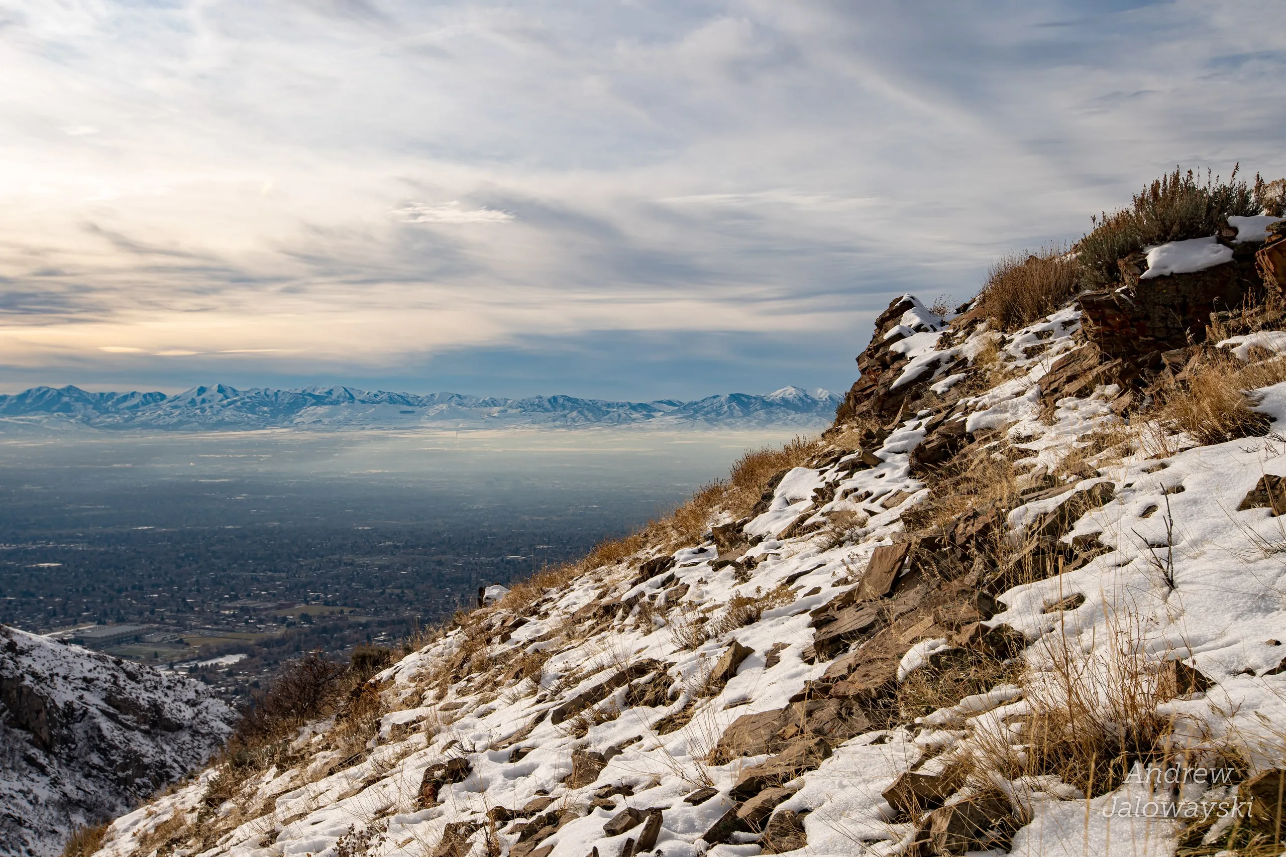 Snowy hillside with brush above the Salt Lake valley