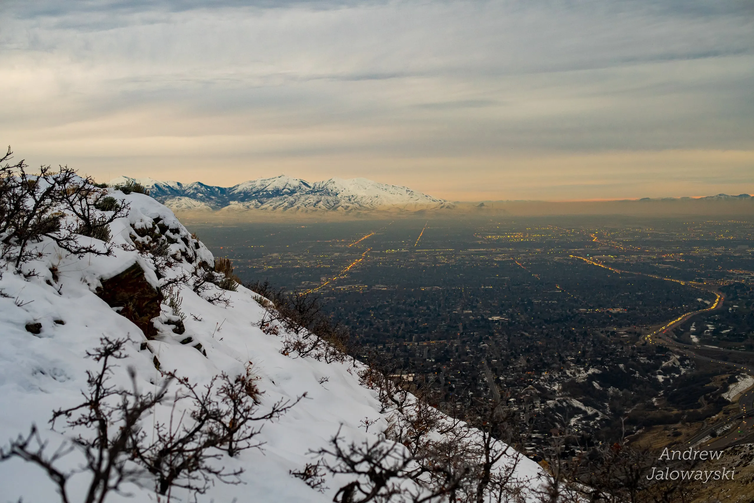 Snowy hillside overlooking the lights of the Salt Lake valley at dusk