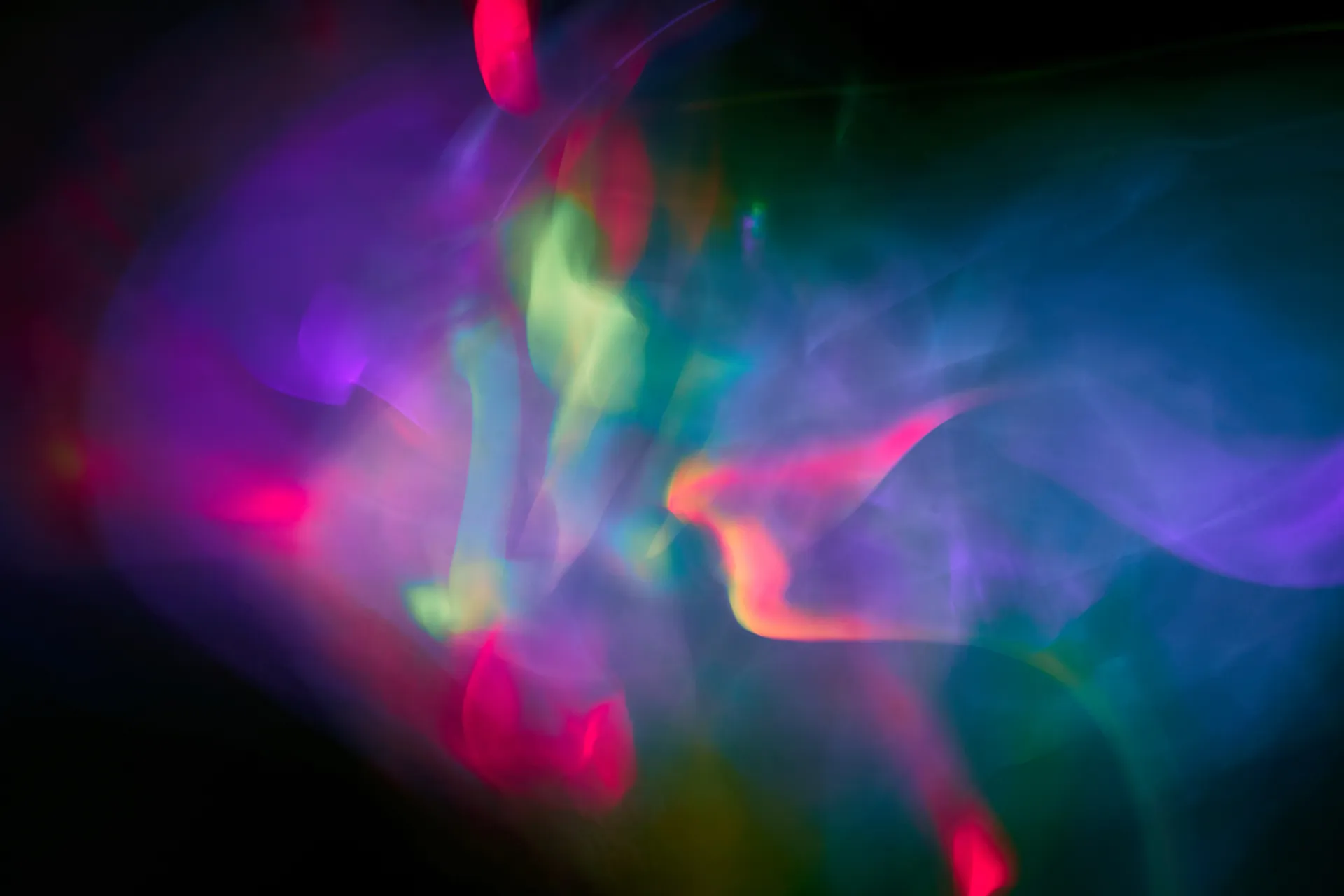 Abstract swirls of pink, green and blue light