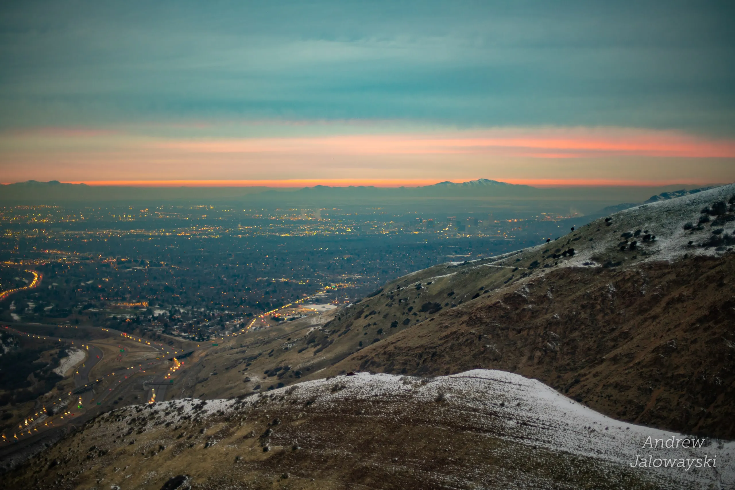 Salt Lake valley glowing at twilight below the mountainside